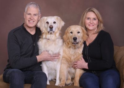 Couple with their pet dogs - English Cream Golden Retrievers