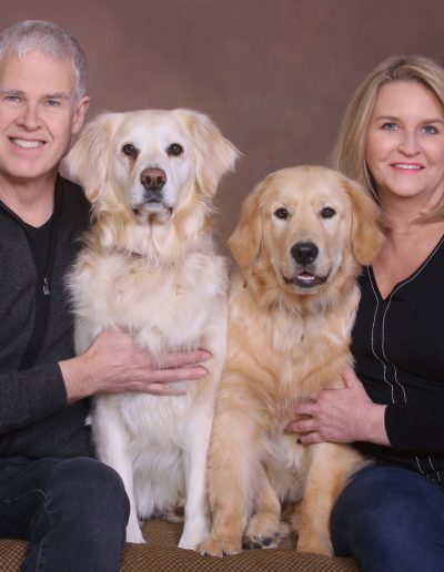 Couple with their pet dogs - English Cream Golden Retrievers