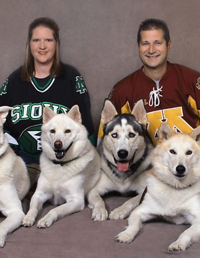 Sports couple with 4 Siberian Huskies UofM Gophers and UND Sioux